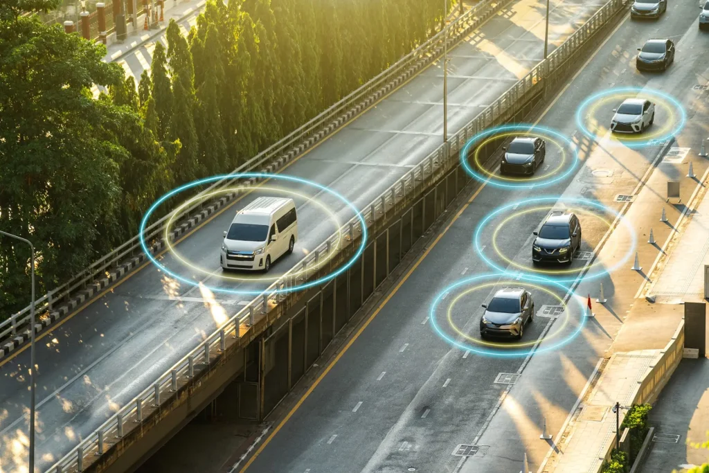 Aerial view of a fleet van and vehicles on a road, each marked with a live telematics tracking ring