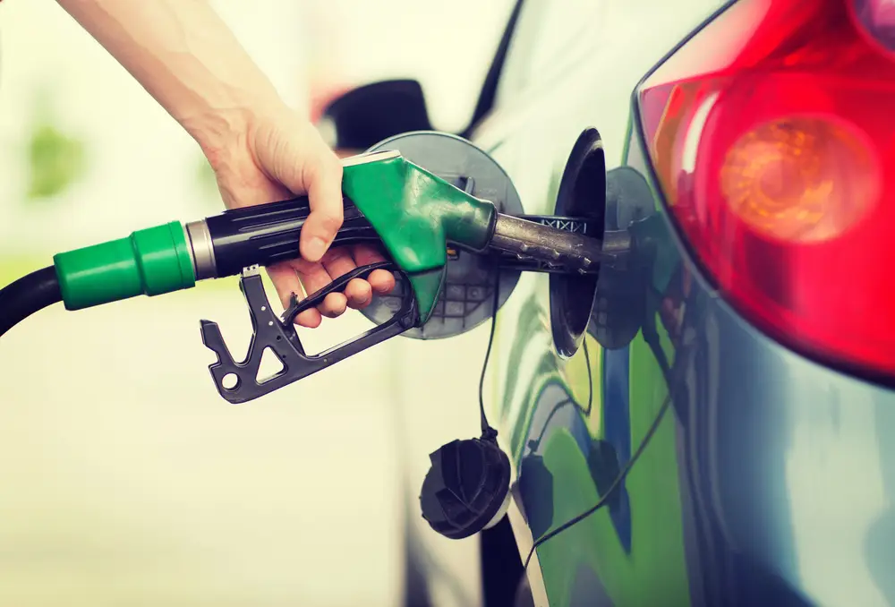 Driver refuelling a business vehicle at the pump, representing fuel tax credits for light vehicle fleets.